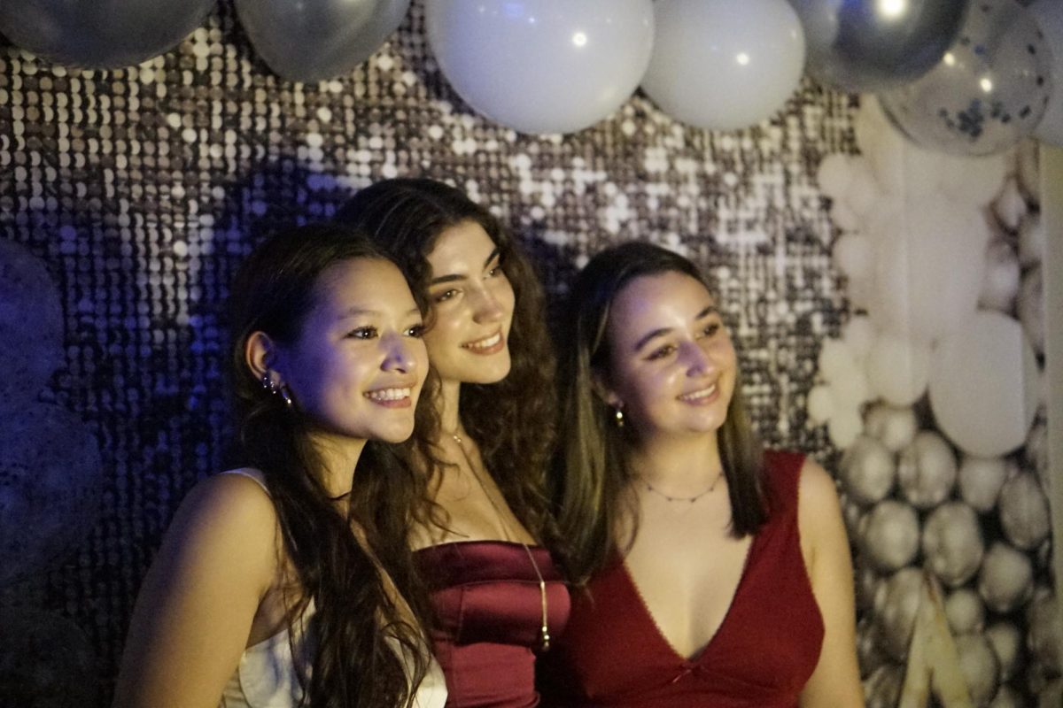 SAY CHEESE!: Seniors Kiki Baker, Kaitlyn Gerrie and Rose Blum pose for a photo during the Homecoming dance, last Saturday. The theme, Saturday Knight Lights, was taken into consideration for Gerrie when she chose her outfit. Gerrie appreciated the time Student Council members took in creating a welcoming and fun atmosphere for all students to enjoy.

“The venue was great, the ambiance was nice and the music was better by miles,” Gerrie said. “The theme was fun and creative and even though most didn’t follow it, we incorporated elements or fully embraced it. I give lots of credits to the Student Council.”

Gerrie said she enjoyed the camaraderie that a dance brings to the student body, saying she hopes the Student Council can host more unique events before the end of her senior year.

“With the end of my time at Mac, I am trying to enjoy all of these different events and go out like for spirit days,” Gerrie said. “I really enjoy these moments when the community can come together and create a fun night with lots of memories. I loved dancing with my friends and making the most of the night.”

Caption by Nate Williams. 