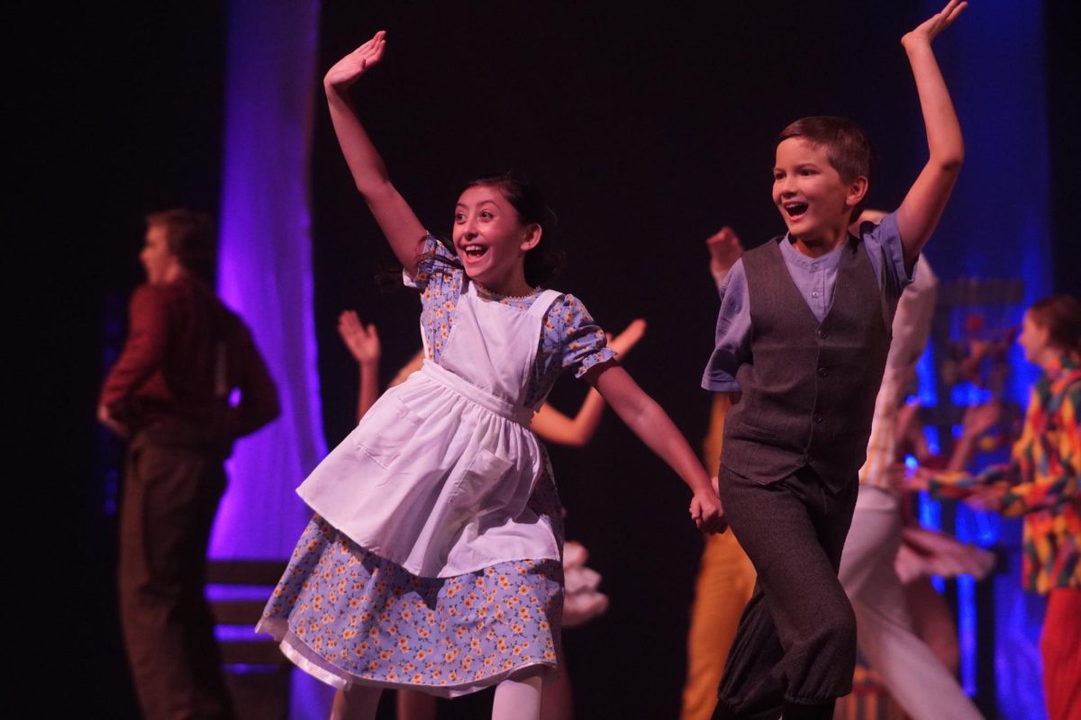 A DELIGHTFUL DANCE: Freshman Gideon Adair performs in the ensemble in Tuck Everlasting and as Angus Tuck on his alternate night. While reflecting upon the show as the performance comes to an end, Adair said it strengthened his connection with the theater community and his confidence on stage. 

Throughout rehearsals the cast remained very close-knit, all working tremendously hard to put on a beautiful show. Adair loved the process of learning the choreography and felt this was due to how good of a teacher, Academy Director Natalie Uehara was.

“My favorite part of producing the show was my castmates, it was just such a wonderful cast, we were all really close to each other,” Adair said.

Adair loved every part of the musical but his absolute favorite was the fair scene. During this scene, Adair performed a duet dance with senior Sophia Rayas.

“My favorite part of the show had to be the fair scene, during which I had a dance part that I thought was super fun,” Adair said.

On his alternate night, Adair got the chance to perform the role of Angus Tuck which he worked tirelessly for as an understudy. Over the rehearsals, Adair enjoyed spending his time working with Joseph Blackwood who played Angus Tuck.

“I was understudying Joseph Blackwood, and he was always so helpful,” Adair said. “I had such a fun and awesome time during my alternate night, I loved getting to perform as Angus Tuck.”

In the end, the musical expressed an important message, which was to appreciate life and all it's experiences. 

“I feel like the best way to explain the message of Tuck Everlasting is when Angus is talking to Winne and he says, you don’t need to live forever you need to just live,” Adair said.

Caption by Tallulah McAuliffe. 
