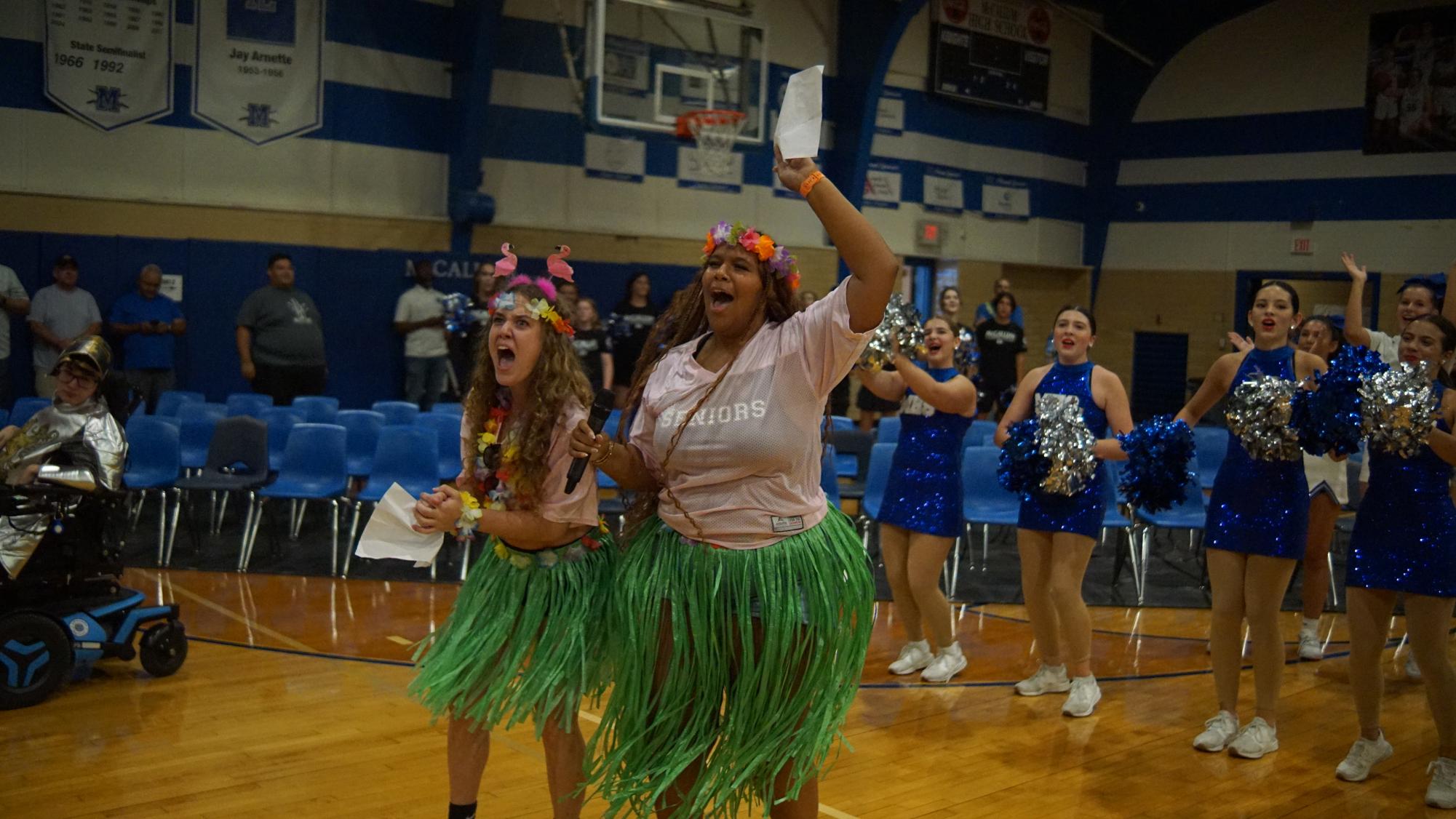 Seniors Julia Rasp and Trinity Ritcherson hype up the crowd at the tropical-themed Taco Shack pep rally on Aug. 29. Rasp said the rally went well, but she was nervous beforehand. "Like insanely nervous," she said. "But the second I started talking into the mic and people were cheering, I felt so much better. Seeing my friends in the crowd helped a bunch too, and I just kept trying to yell and keep the energy up."