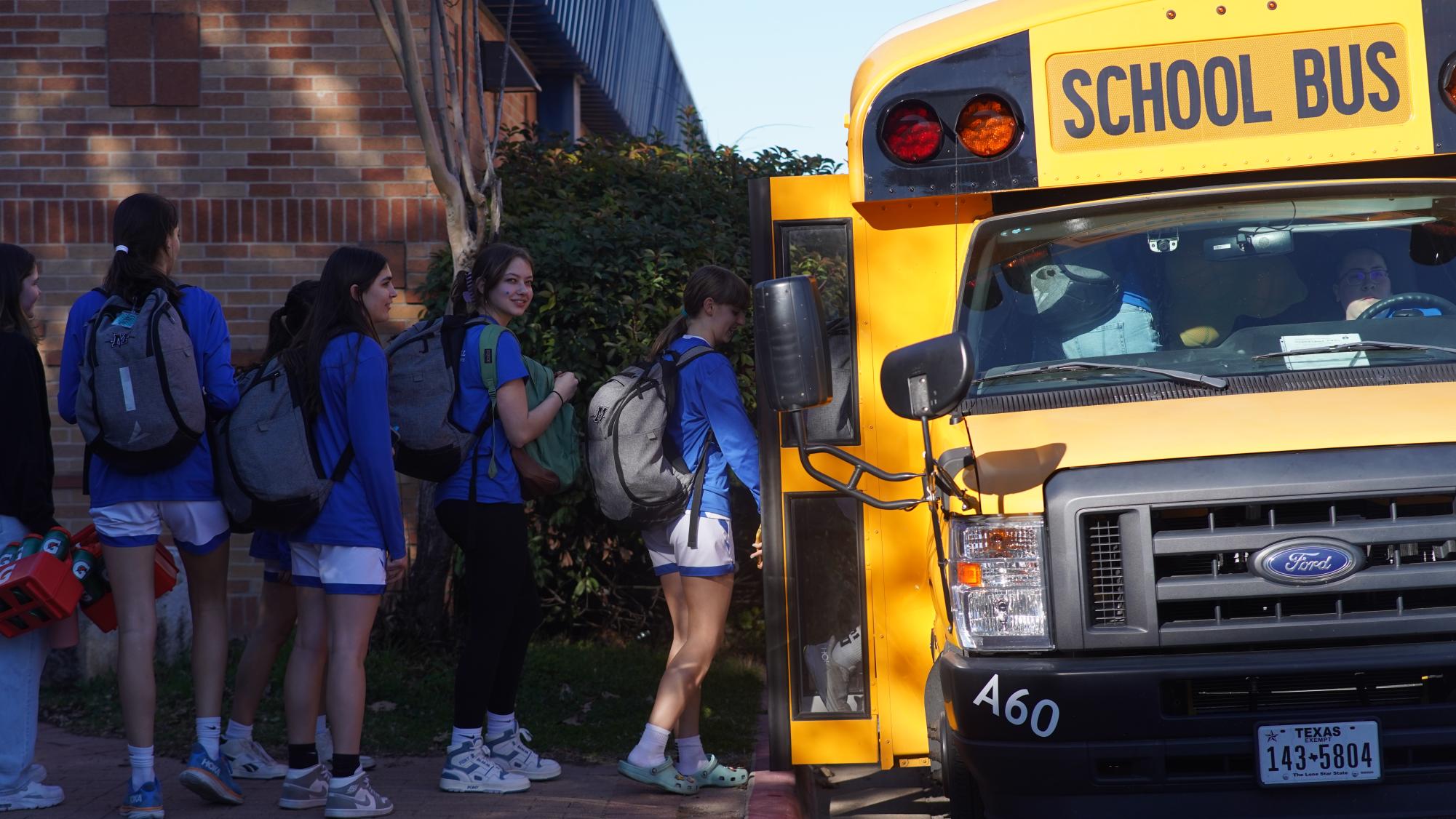 Senior Sonya Petersen boards the bus during the girls basketball playoffs send off on Feb. 13 last year. 