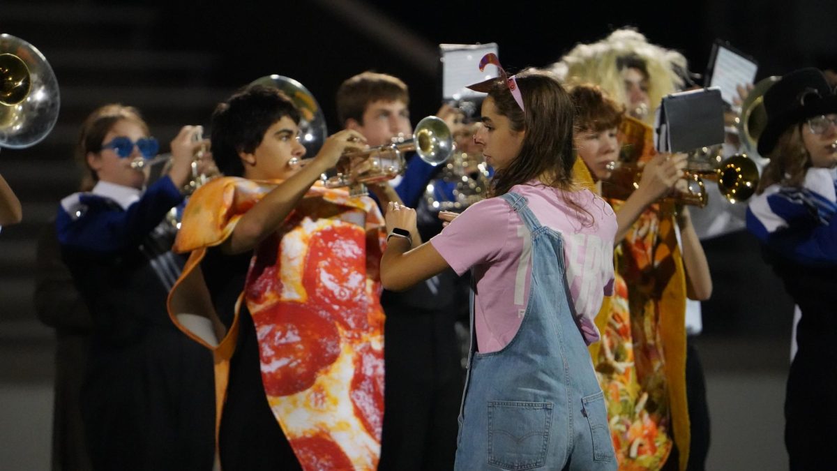 Drum Major Sara Hamlet conducting the band before the halftime performance at the football game against Navarro. 