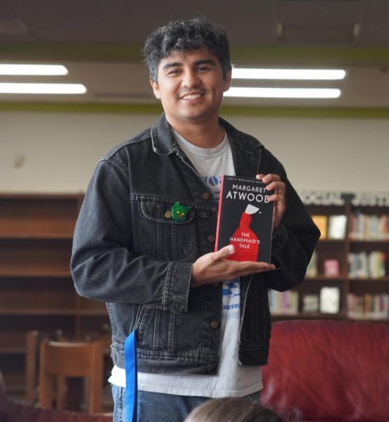 Zuniga holds a copy of the Handmaid's Tale, donated to the Banned Book Club by Black Pearl Books, on Nov. 13.