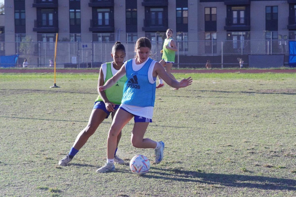 Astrid Huerta and Shoala Houston compete for possession in a scrimmage during practice on Nov. 14.