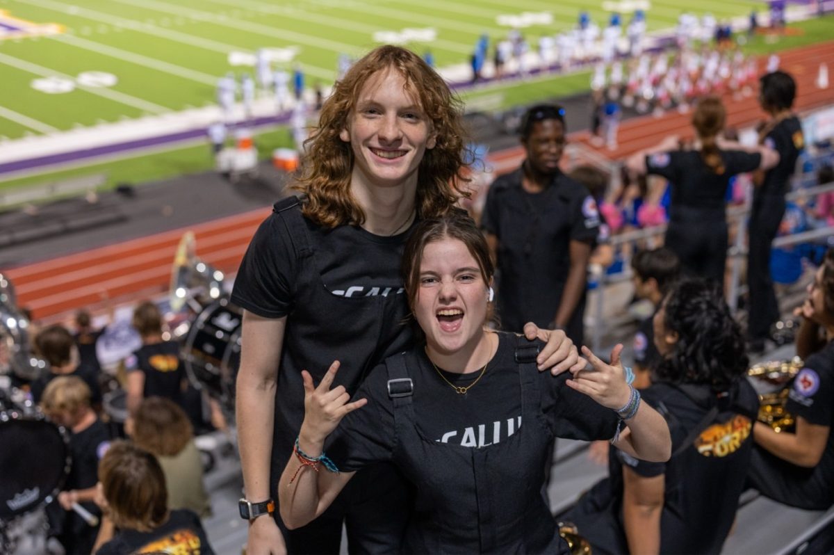 Martina Lorenzo-Serrano (right) and Gray Gaddis (left) pose for the camera during the Liberty Hill football game.