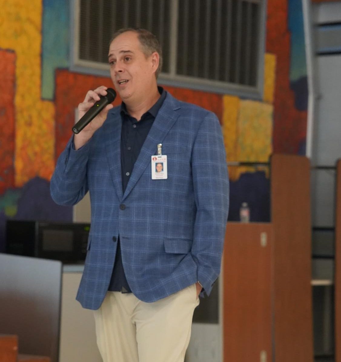 Principal Andy Baxa speaks at a meeting with McCallum parents and an AISD police officer last year.