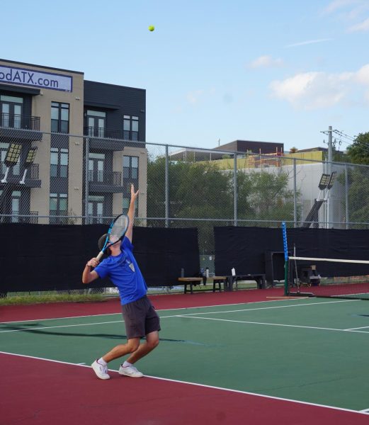 Senior Vincent Carney serves in practice on Dec. 16. Photo by Elizabeth Nation.