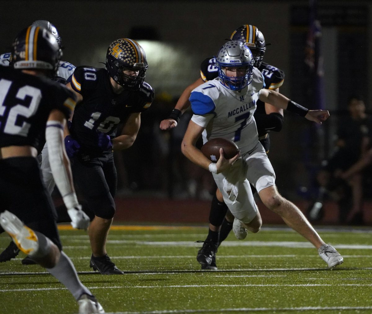 HISTORIC OFFENSIVE OUTPUT: Senior quarterback Luke Dunham looks downfield after evading the initial defenders for a positive gain in the fourth quarter of the Knights' 78-57 loss at eventual district champion Liberty Hill on Oct. 25. While the game did not end in the victory for the Knights, the moral victory of putting up 57 points on a team of Liberty Hill's caliber and the offensive statistics achieved during the game make it a historic day for McCallum football despite the loss.

Dunham must have achieved the best statistical day ever for a McCallum quarterback. He threw for 501 yards and five touchdowns and also rushed for 131 yards and two touchdowns on eight carries. Those gaudy numbers increased his passing yards per game average to an impressive 316.6 passing yards per game at that point in the season.

Senior wide receive Mark Sanchez had a similarly stellar game statistically on both sides of the ball. On offense, he hauled in 14 passes for 255 yards and three touchdowns. On defense, he made 14 tackles. Heisman winner Travis Hunter would love to have had a two-way game with those stats.