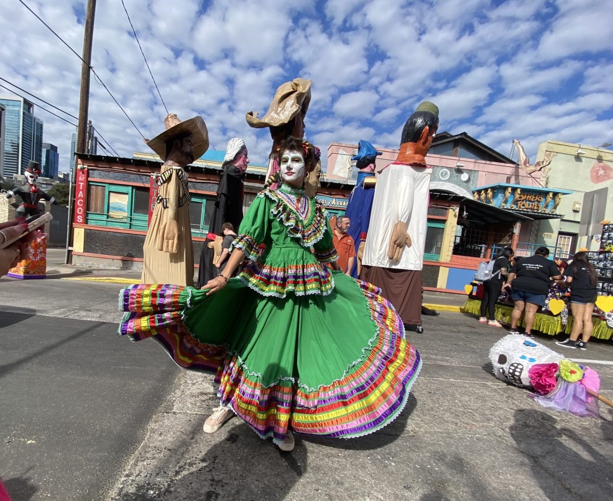 Preparing to march in the Dia de los Muertos parade, Harlow Mallison twirls through the streets of downtown Austin. Mallison is a sophomore in the Spanish 2 class at McCallum and was invited to join the annual Dia de los Muertos celebration with Ballet Folklorico, which walked through Fifth and Sixth streets. " I had a lot of fun and it was nice meeting new people," Mallison said. "I loved how everyone came together and were so supportive of each other."