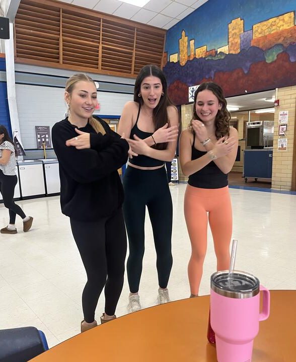 Juniors Paige Mitchell, Amelia Cahoon, and Larkin Long create a TikTok in the cafeteria during group photo day day on Wednesday Jan. 15.