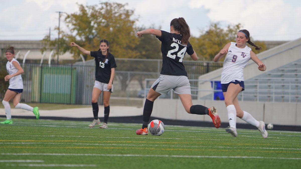 Shiloh Hendrickse (24) passes the ball up to Junior Maya Tackett during the first game of preseason, vs Eastview HS, which the varsity girls soccer team won 3-0