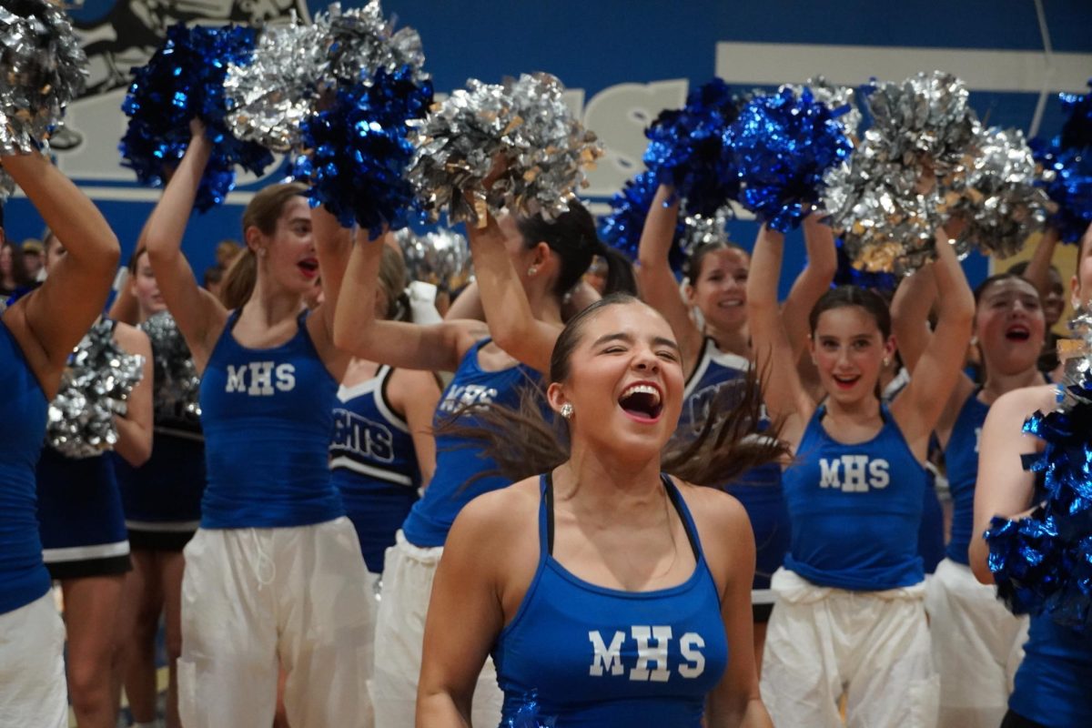 Junior Chloe-Seckar Martinez gets the crowd hyped up at a pep rally on Sept. 20. Photo by Sophia Manos.