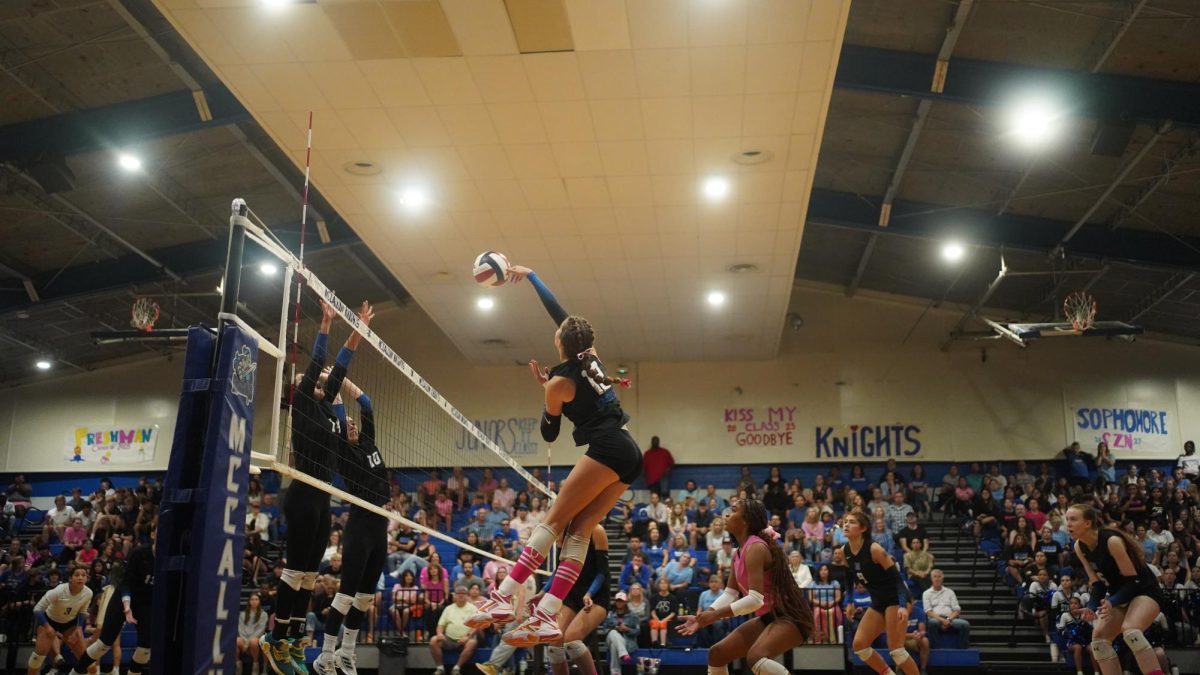 Freshman Piper Adair spikes the ball over the net on Oct. 1 against the Ann Richards Stars. The Knights swept the Stars at home in three sets. Photo by Callen Romell.