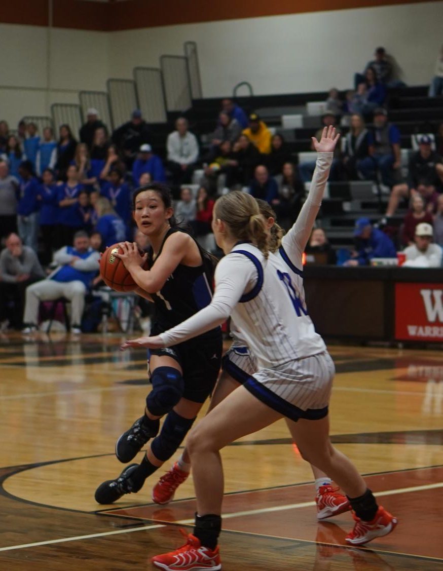 Senior point guard Emy Chen finds resistance as she strives to drive to the hoop from the top of the key during the Knights' bi-district round playoff loss to Georgetown at Westwood High school. Chen said after that the Knights had a distinct height disadvantage but not played with heart and intensity despite being overmatched.