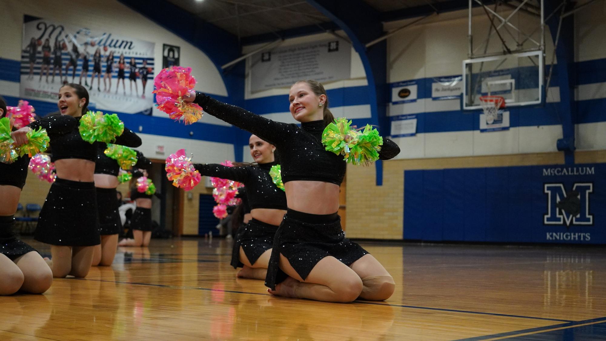 Senior Captain Catherine Haikola performs the team's "pom" contest dance to a Pitbull remix at halftime during the boys' varsity basketball game on Jan. 28 in the large gym.  Caption by Josie Mullan. Photo by Julia Copas.