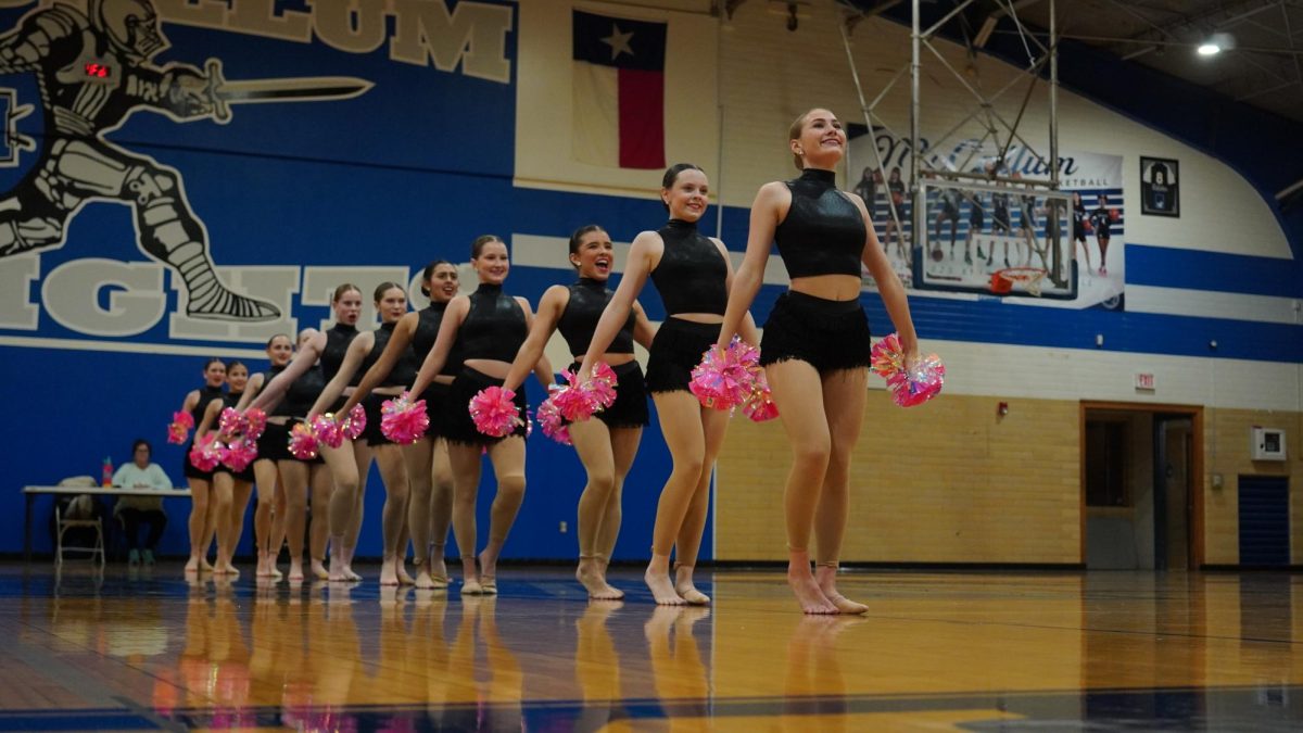 THE POM ENSEMBLE: The Blue Brigade took the stage at the gym last Wednesday to host its annual pre-contest showcase. The team performed all of its dances for a small audience, to help them prepare for the upcoming competition season. Sophomore Lauren Brewer, a member of the pom ensemble, said the show-off helped the team grasp what competition would be like.

“The show-off helped a lot with preparing for the contest because it gave us a chance to perform our dances in front of an audience and practice on a gym floor before the contest,” Brewer said.

To be in the pom ensemble, dancers must survive tryouts.

“Our pom ensemble is a super fun dance because it is upbeat, and I really like the choreography and songs in the mix,” Brewer said. “It's also a fun experience to get to be in the dance as it is a selective group of dancers.”

Caption by Sienna Martens. Photo by Julia Copas.