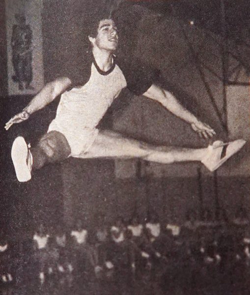 USING MUCH the same skills in gymnastics as he did for the cheerleader tryouts, Mark Pourmanafzadeh does a "Texas T" for the audience.