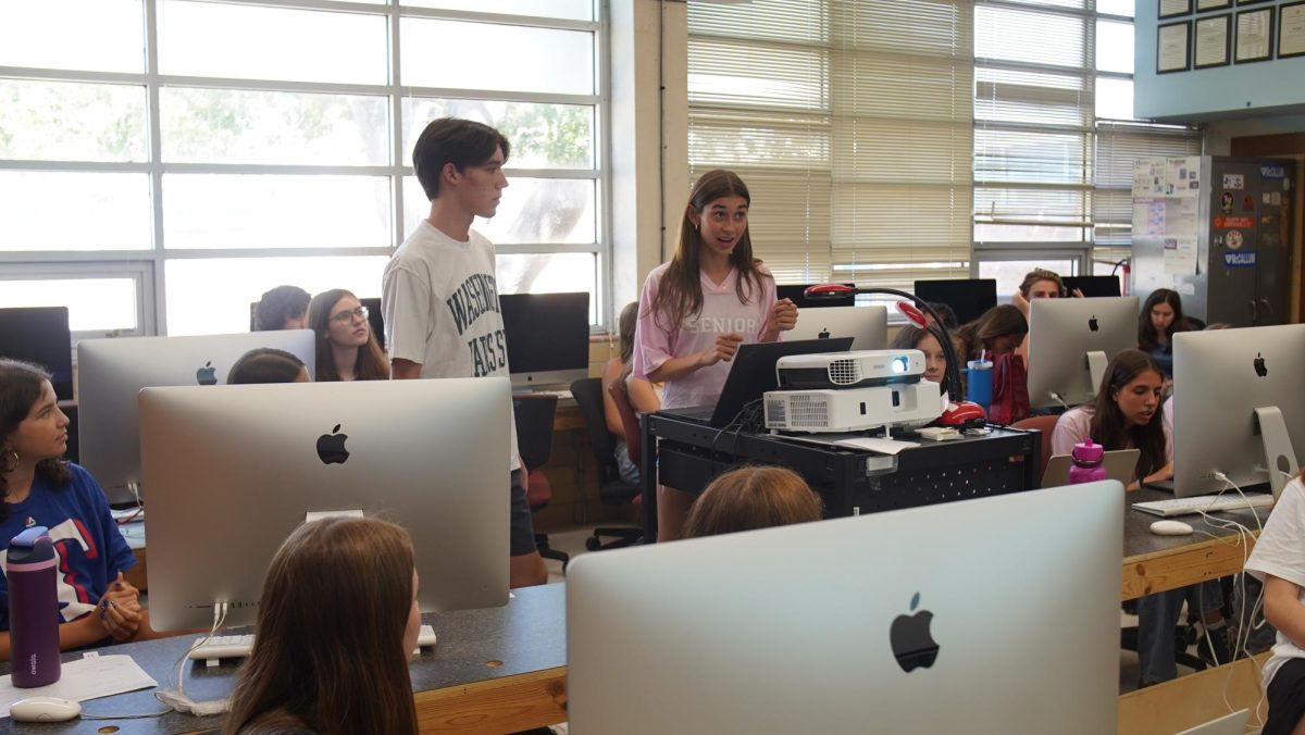 Co-Editors in Chief Chloe Lewcock and Nate Williams instruct eighth period newspaper class on weekly plans, events, and deadlines.  