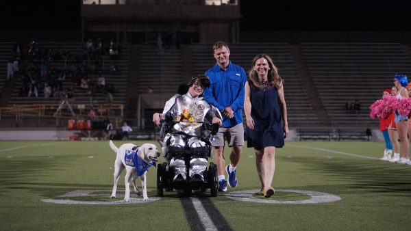 Senior Ben Polega poses with parents Jeff and Victoria Polega and their dog Friday for the football team's Senior Knight.
