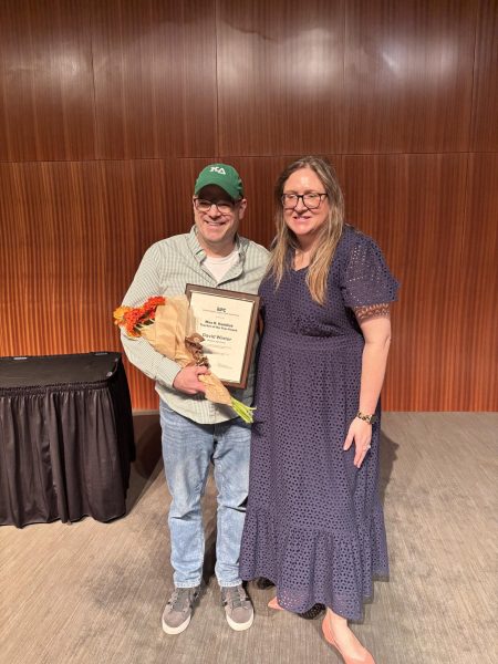 Shield adviser Dave Winter poses with his 2025 Max Haddick Texas Journalism Teacher of the Year Award and ILPC director Alyssa Boehringer, who presented Winter with the award at the ILPC Awards Ceremony on April 13 at the LBJ Auditorium.