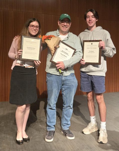 Flanked by staff reporter Beatrix Lozach and co-editor in chief Nate Williams, each holding one the Shield's 2025 ILPC Gold Star Awards, Shield adviser Dave Winter poses with his 2025 Max Haddick Texas Journalism Teacher of the Year Award on April 13 at the LBJ Auditorium.
