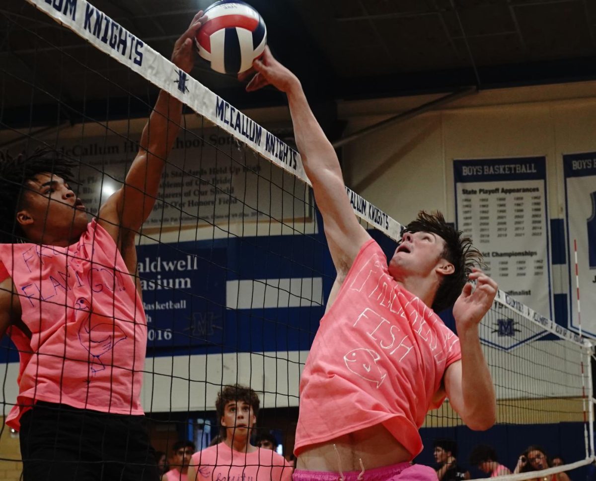 Senior John Scott Mabry jumps up to block ball from senior Devon Robinson for the match of the Senior Boys's A Team against the Senior Boys' B team during the Bro-Ball tournament held on Wednesday. The Senior A Team ended up taking home the championship title at the end of the rounds. The tournament which is annual serves as a fundraiser for the volleyball program at McCallum. The volleyball team is responsible organizing the event and coaching the players beforehand.