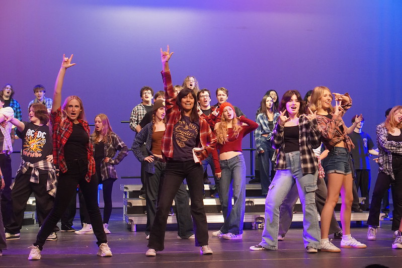 COMING TOGETHER: Sophomore Camilla Miculek performs a small solo during the group performance of “American Idiot” by Green Day for the dress rehearsal on Saturday. Miculek was in two other performances along with “American Idiot,”  “Jolene” by Dolly Parton  and “Looking On the Bright Side of Life” by Monty Python. 

Miculek said she loves seeing the show progress over time in rehearsals to become the grand production that it is. 

“I love seeing all the other classes dancing and singing and coming together during rehearsals,” Miculek said. 

Despite her practice, Miculek admitted that she did feel a bit nervous on stage, but overall said the show went great. 

“I had a small solo, and I’m not super experienced in performing,” Miculek said, "but I had a lot of fun in the end, and I was really happy that I stuck it out with my friends.”

Since Miculek has been in choir for two years now, this year’s Cabaret performance was another choir memory added to her book.

Caption by Carlo Hinsdale. Photo by Katie Martin. 