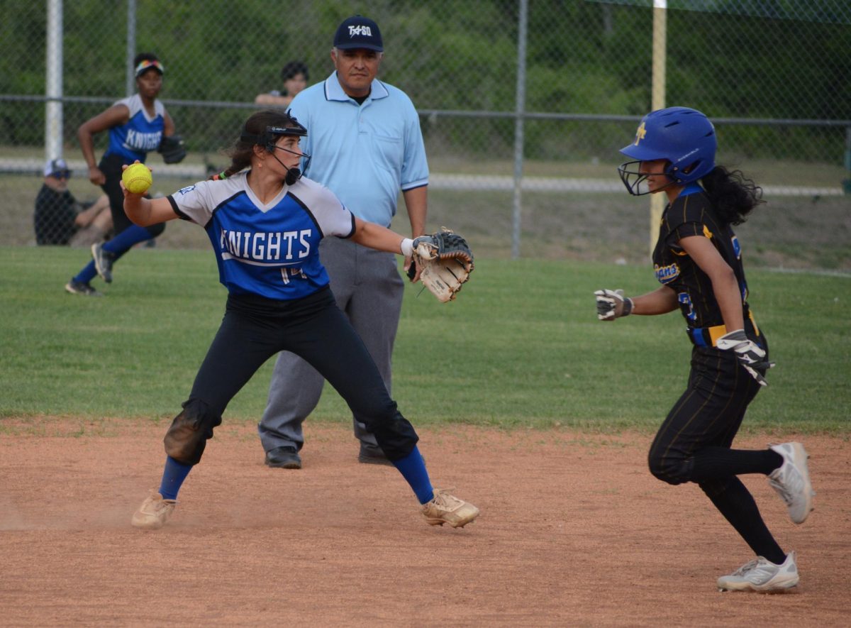 After fielding a ground ball by Trojan center fielder Taylor Coggin, second baseman Tallulah McGolgin ignores Anderson baserunner Genesis Ruiz, opting instead to throw to first baseman Jay Sachez in order to retire Coggin for the final out of the first inning. Pitcher Natalie Myrick had gotten the first two outs of the inning via strikeout. Ruiz singled between the two strikeouts. 