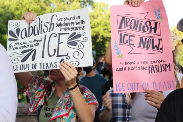 Unidentified protesters outside the Texas Capitol hold up signs advocating the abolition of ICE at an Austin protest rally against recent ICE actions in Los Angeles.