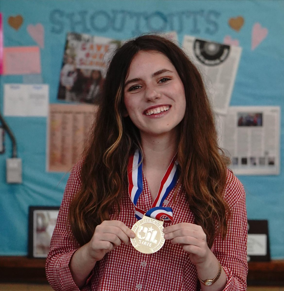 Junior Beatrix Lozach is all smiles while wearing her gold medal as the 5A state champion in ready writing. She also placed fourth in the 5A classification at State in headline writing. 