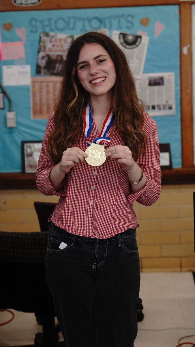 Junior Beatrix Lozach is all smiles while wearing her gold medal as the 5A state champion in ready writing. She also placed fourth in the 5A classification at State in headline writing. 