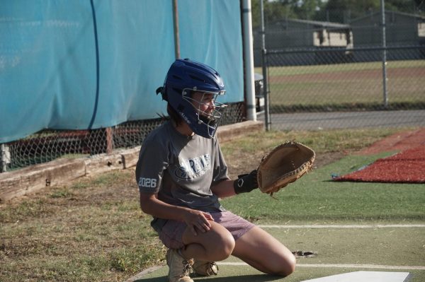 CALLING THE PITCHES AND THE SHOTS: Senior Grace Yemington catches pitches behind the plate during the softball team’s fall ball practices. 
For Yemington, softball has been a part of her life for 12 years and catching’s a family tradition.

 “My older sister was a catcher, so I decided to follow in her footsteps,” she said.

Consistently serving as a reliable player for the team, Yemington now thrives in the leadership side of the position. 

“I like being able to sort of conduct the infield; help call pitches, remind infielders of the play, and play an important role on the field,” she explained.

Looking ahead, Yemington is primed and ready to close out her senior year strong.

 “I’m looking forward to this season and excited to continue playing fall ball with the team this year,” she said.

Caption by V Overstreet. Photo by Magnolia Smith.
