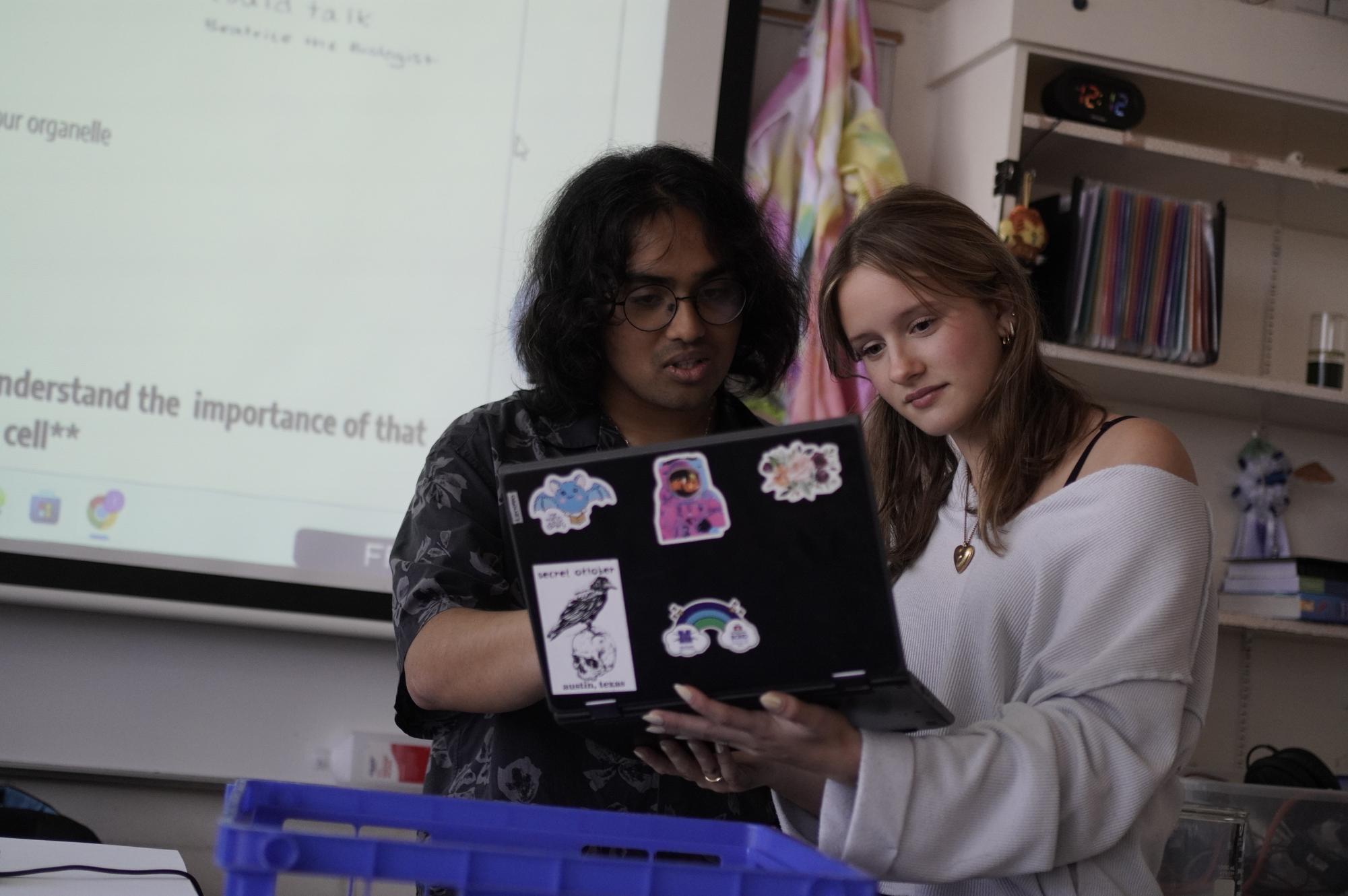 AP Biology teacher Ishan Saharoy assists junior Berit Ellwanger during class.