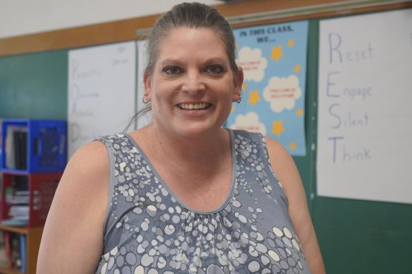 Amy Brodbeck, head volleyball coach, head of the english department and student Council, poses for picture. 