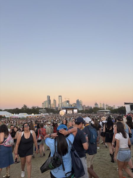 The Friday crowd as the sunsets at ACL 2024 with the Austin skyline in the back.