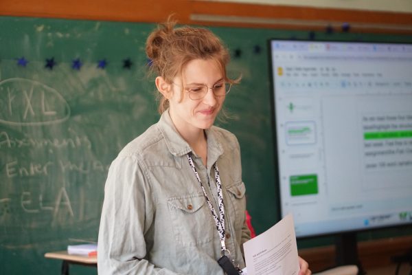 FROM PLAYGROUNDS TO PLAYWRIGHTS: In room 103, one can find a bustling classroom of students lively chatting and working. The new English teacher, Abigail Pfeiffer, said she feels quite at home here. 

“I love the students here,” Pfeiffer said. “It’s been such a pleasure to teach them.”

This is Pfeiffer’s second year of teaching. Her previous teaching experience was for a fourth grade classroom. Some might say fourth grade to 10th is a huge jump, but Pfeifer has been facing it with great enthusiasm. She majored in English in college and finds that a high school setting gives her more room to explore her passion. 

“There’s much more freedom when teaching high schoolers,” Pfeifer said. “I really get to put my skills to work.”

Pfeiffer was drawn to McCallum because of its commitment to Fine Arts and its welcoming community. So far, her experience at Mac has not let her down. 

“It’s clear how passionate students are, and it’s very inspiring to see,” Pfeiffer said.

Ultimately, Pfeiffer’s hope for this year is for her students to feel accomplished and for her to feel as if she taught them something worthwhile. 

Caption by Zanna Allen.
