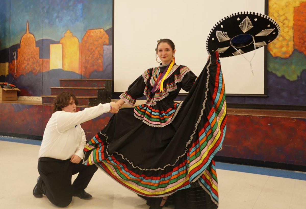 HONORING HER HERITAGE: Last Tuesday, McCallum’s Ballet Folklorico put on a showcase in honor of Hispanic Heritage Month. Senior Abigail Peacock says it was nice for Folklorico to showcase their traditional Hispanic folk dance during Hispanic Heritage month, due to the fact that they are no longer able to perform for Cinco de Mayo. Because of the new Texas laws that prevent certain cultural groups from performing, Peacock says they will take what they can get, and Hispanic Heritage Month was the perfect opportunity to celebrate dance. 

“To me, it's important that Hispanic Heritage Month is celebrated at McCallum because it's an integral part of our school's culture,” Peacock said. “Additionally, it's especially important that we are able to dance for Hispanic Heritage Month because we may not be able to put on a Cinco de Mayo this year. Our club works hard, and I think there should be a way to showcase our hard work to the school.”

Peacock says the Folklorico dance is an important part of Hispanic culture, and can represent various Hispanic cultures and backgrounds through music and art. 

“Folklorico is representative of the different cultural influences that come together to create Hispanic culture,” Peacock said. “Folklorico originated as a combination of indigenous and Spanish-style dances, and can represent different regions of Mexico that have unique dance attire and steps that show even more specific influences and history of the individual regions.” 

For Peacock, the community that surrounds Folklorico is what makes the club such a welcoming and fun environment where students can spread Hispanic culture. 

“My favorite part about being in Folklorico has been learning about and being able to experience Hispanic culture. It is what makes Texas so special, and I have loved becoming more involved in the community that surrounds me,” Peacock said. “I've also loved meeting everyone involved in Folklorico, from teachers to club members and people involved in our events. It really has been such a wonderful experience.” 

Caption by Sofia Saucedo. 
