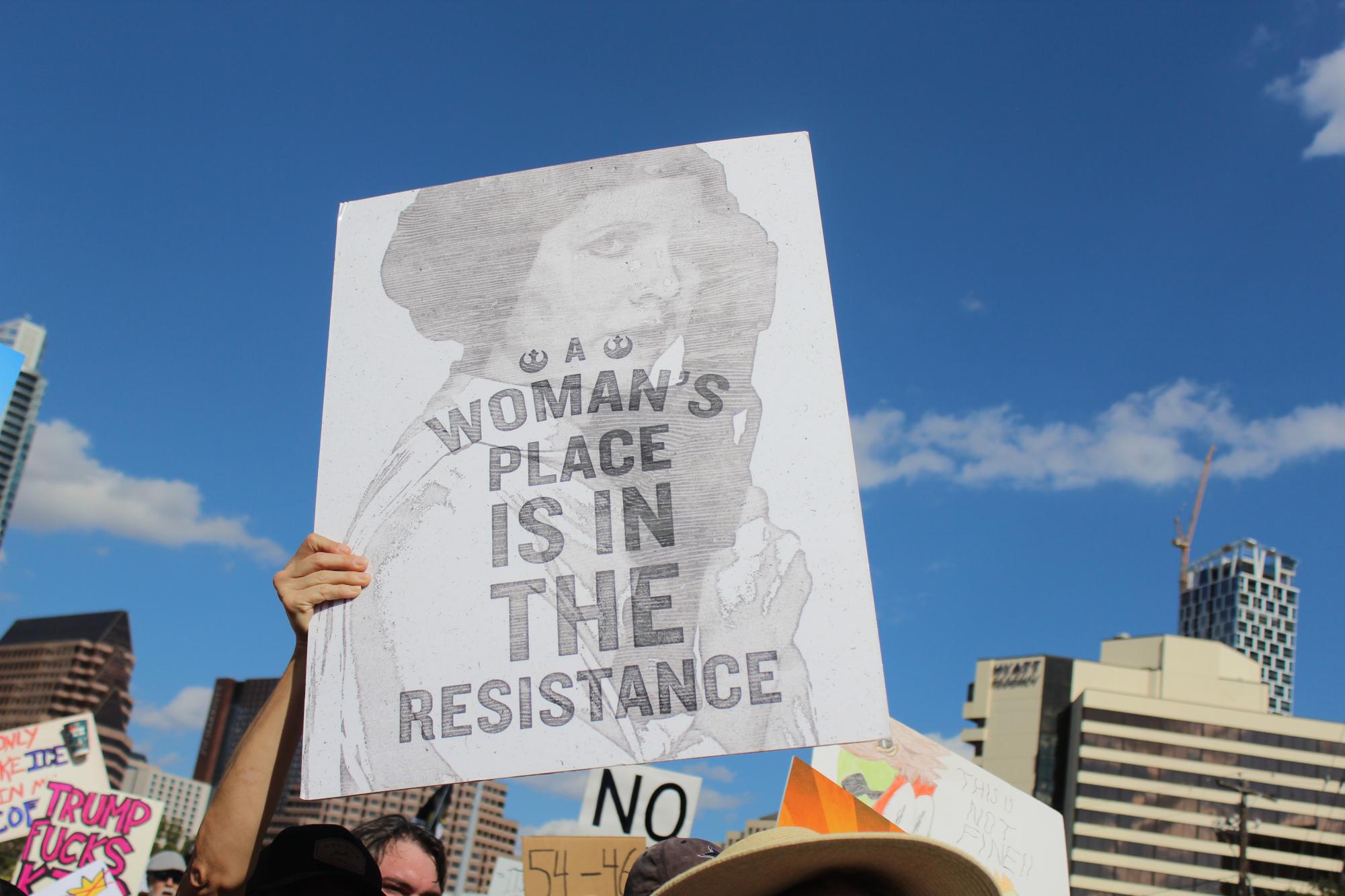 A protestor holds up a sign likening the 50501 movement to the fictional resistance in Star Wars, while highlighting systemic misogyny.