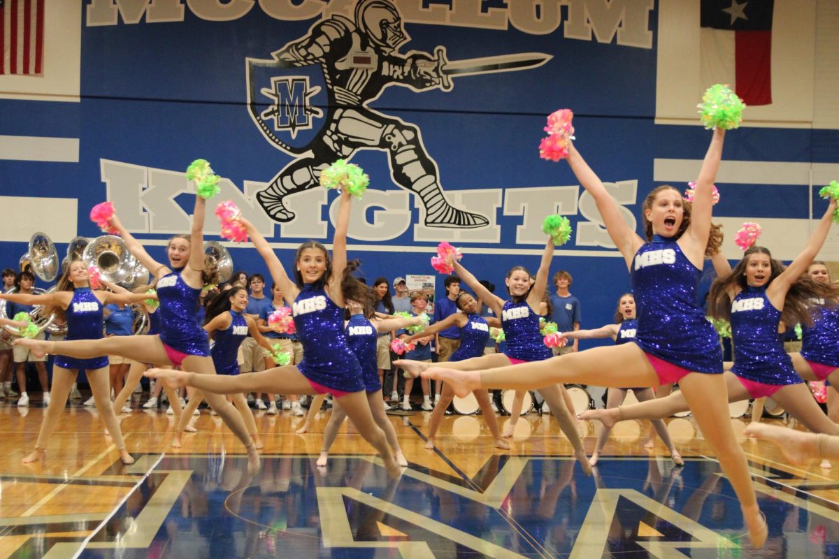 BLAST FROM THE PAST: Blue Brigade junior lieutenant Emma Simon performs a pom dance to Britany Spears' "Womanizer" during the Homecoming Pep Rally. The dance was brought back from the 2022-2023 season, and dancers like Simon found joy in watching the seniors' nostalgia and enthusiasm.

“The dance we did was brought back from [the seniors’] freshman year, so it was really fun seeing the seniors get excited about a nostalgic dance,” Simon said.

Simon has found herself enjoying the pep rally as a whole, as well. She notes that they are more about the pep portion rather than the dancing itself, but still finds joy in performing at them.

“I love pep rallies, I think they’re a lot of fun,” Simon said. “I do think they relate more to school spirit than dance, but it’s always fun to put on a show for the school.”

This won’t be Blue Brigade’s last performance. Simon gives a look at their upcoming performances and where fans can see them next.

“Blue Brigade performs at just about every football game, as well as our competitions in the spring, and our spring show that is performed in April,” Simon says.

Caption by Sam Nash.