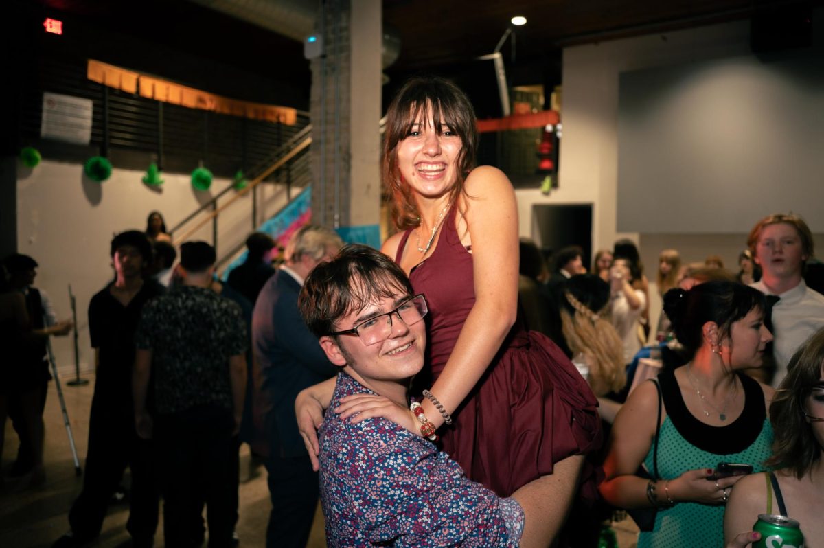 DANCING WITH FRIENDS: Juniors Riley Poole and Boris Lingo dance during this year’s homecoming dance. Lingo and Poole spent the night dancing and talking to friends at the dance. Although Lingo did not attend the dance’s entirety, she enjoyed being able to hang out with friends.

“The social aspect was definitely the best,” Lingo said. “The location of the venue was [also] lovely, I really like being downtown and the weather was pretty great too.”

Lingo also participated in the football game aspect of homecoming with the color guard. Lingo believes that performances in general this year have gone well. As a member of the on-campus group PALS, Lingo found a few challenges with regard to purchasing tickets to the dance. As a junior, Lingo struggled to get to the ticket line during lunch since Pink Week was at the same time.

“It was really frustrating to have pink week be the same as ticket sales,” Lingo said. “What I think would’ve solved this would’ve been online ticket sales. It would’ve fixed every issue I had with the tickets.”

Despite this early challenge, Lingo was still able to get tickets in time and attend the dance. According to Lingo, she had a great experience with the dance and would attend again next year.

Caption by Riley Pita.