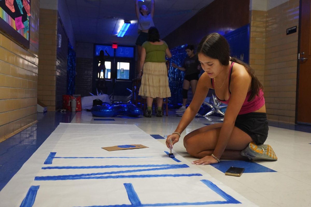 Senior        Medina decorates the senior hallway for Homecoming week.