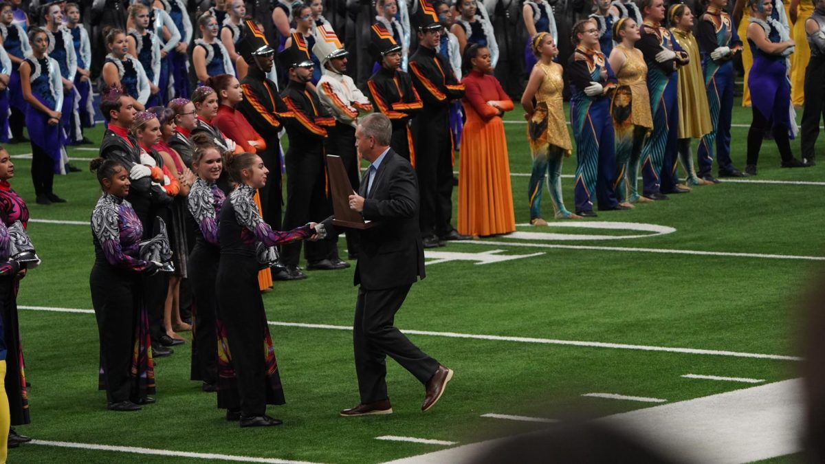 Drum major Sara Hamlet accepts the state finalist trophy.