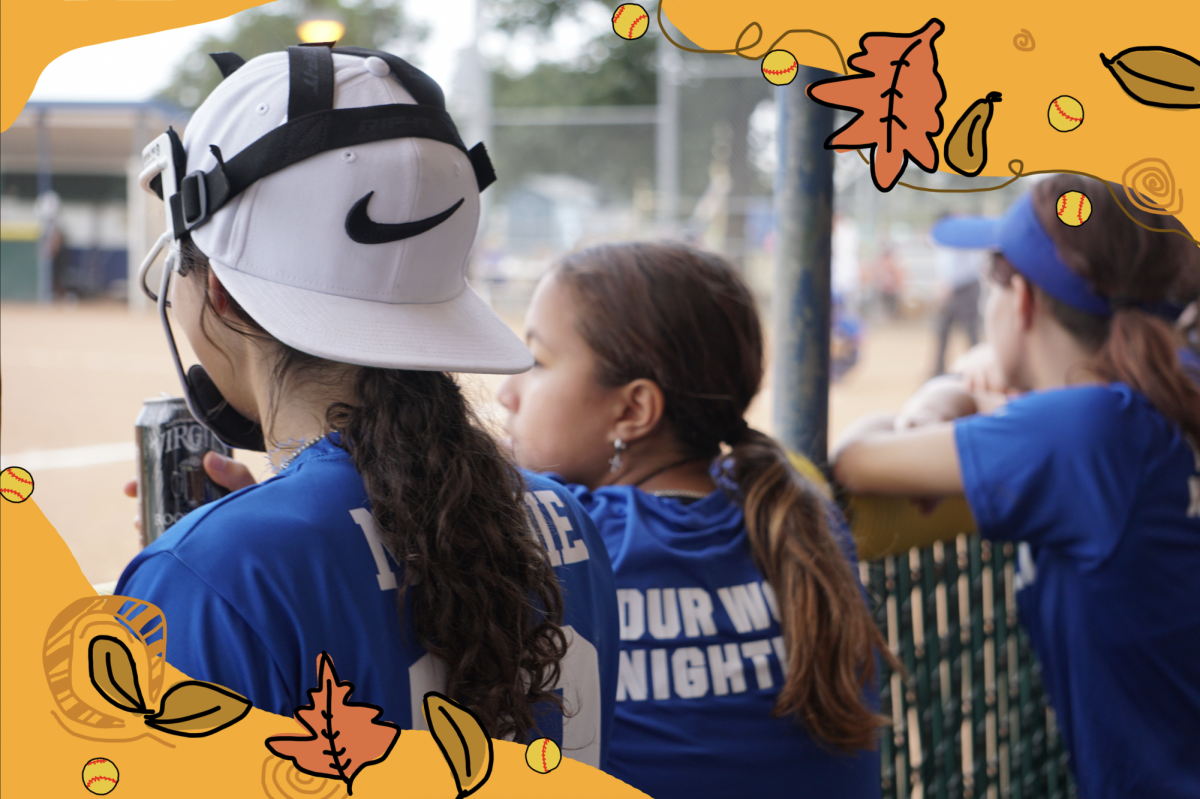 Freshman Maddie Beasley and Emelia Vences and junior Teddy Smith cheer on their teammates during a fall ball game against Vandergrift on Sept. 15.