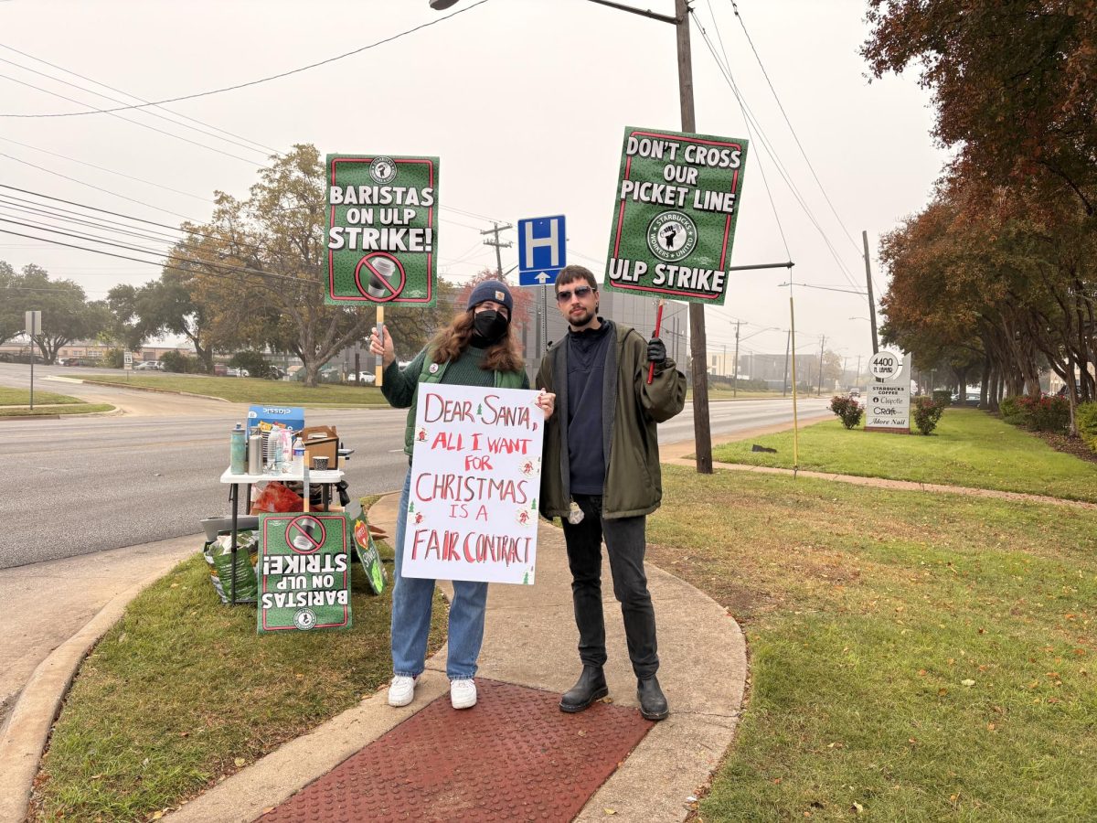 Union workers stand on North Lamar protesting for fair wages and better working conditions.
