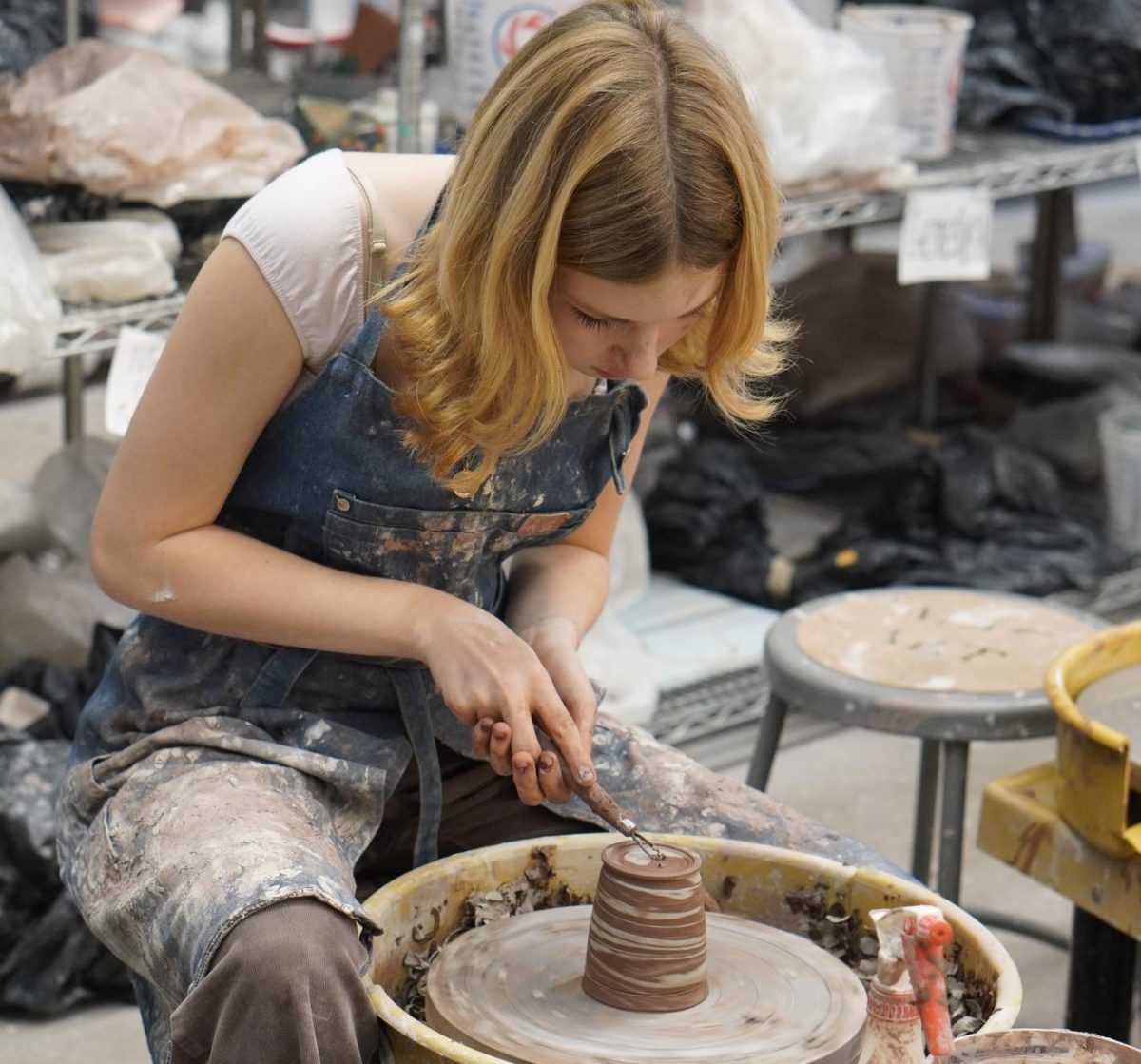 Junior Camilla Miculek works on a bowl in ceramics class. 