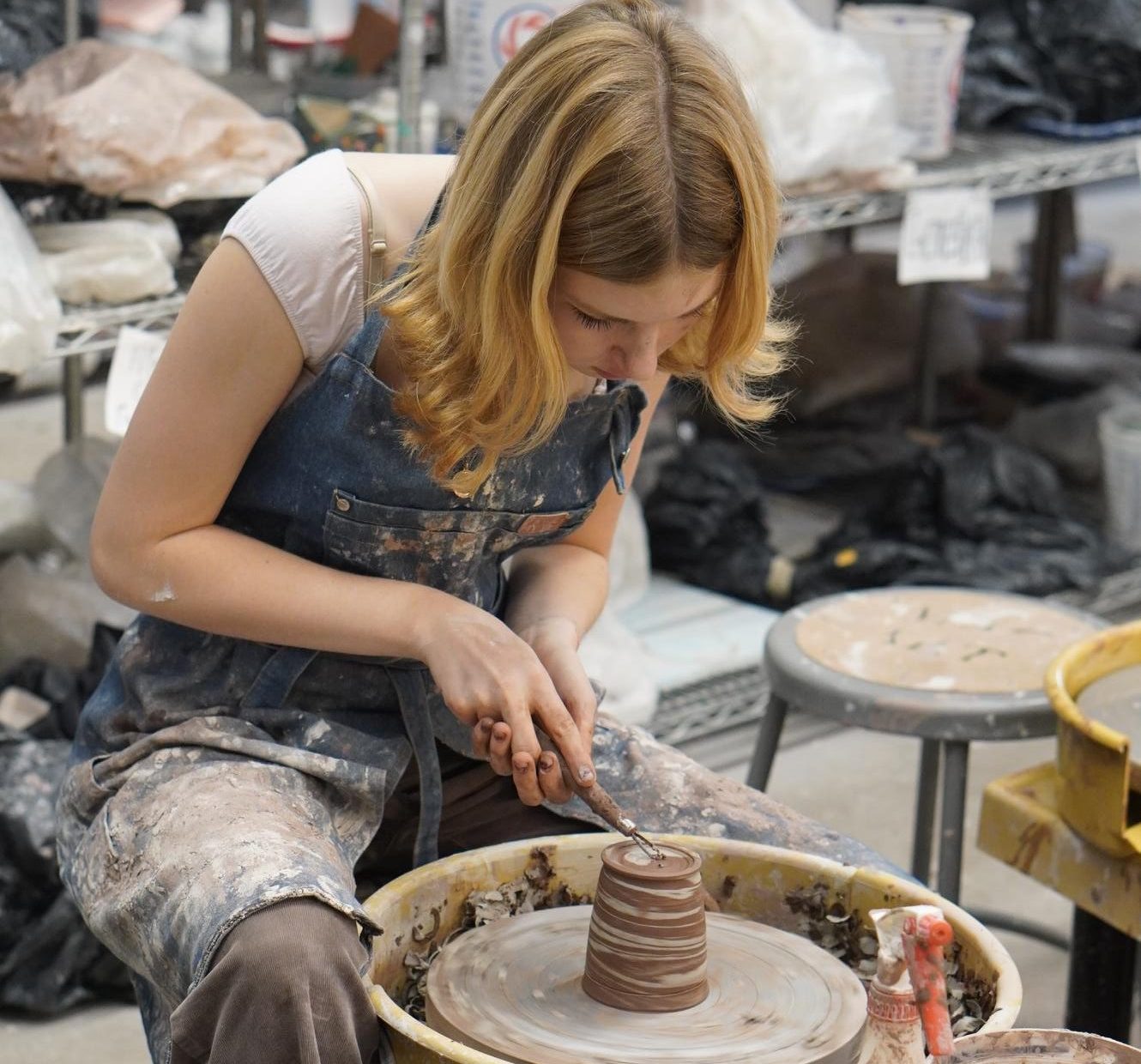 Junior Camilla Miculek works on a bowl in ceramics class. 