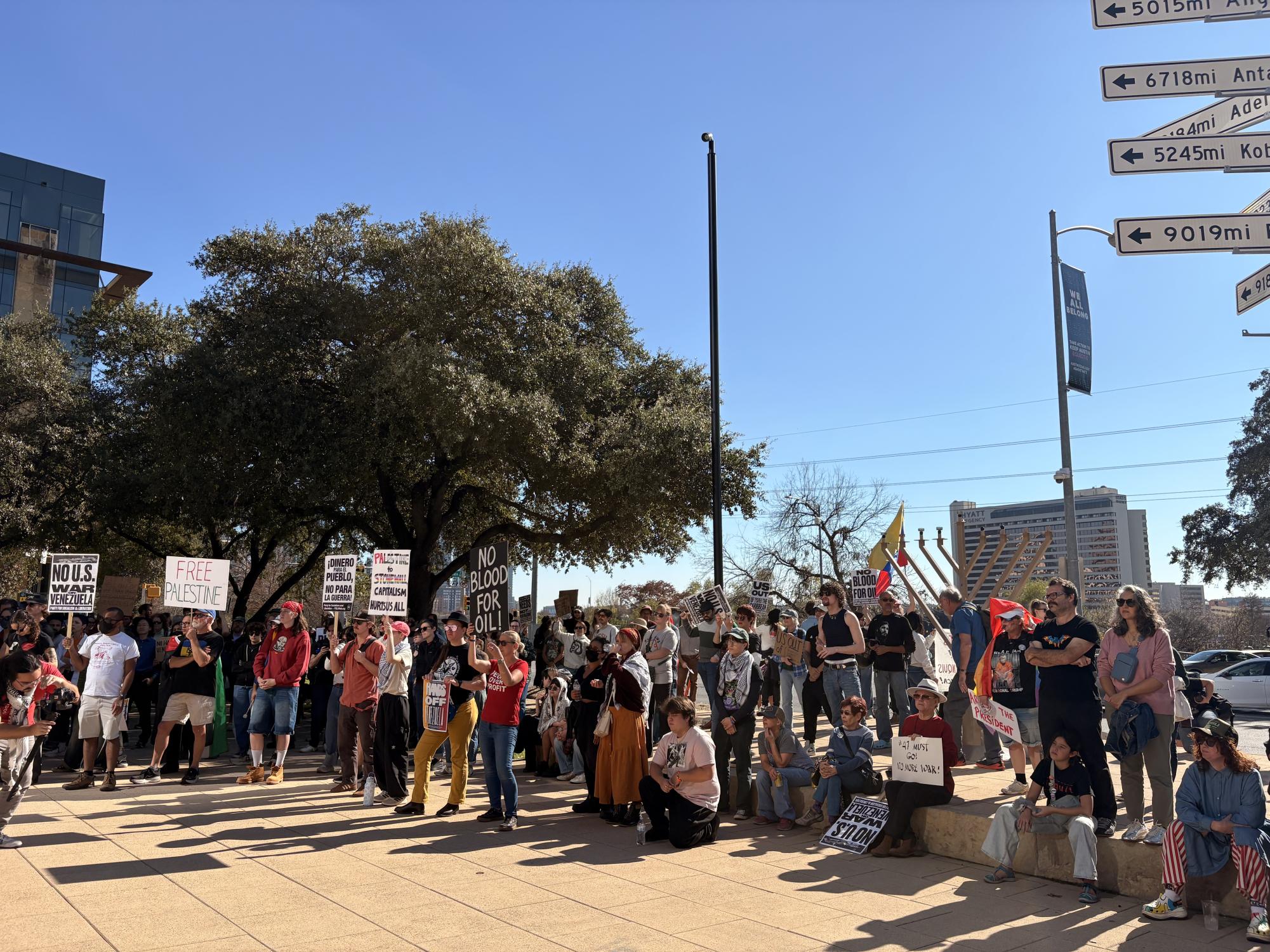 Protesters gather around Austin City Hall to protest US military action in Venezuela. 