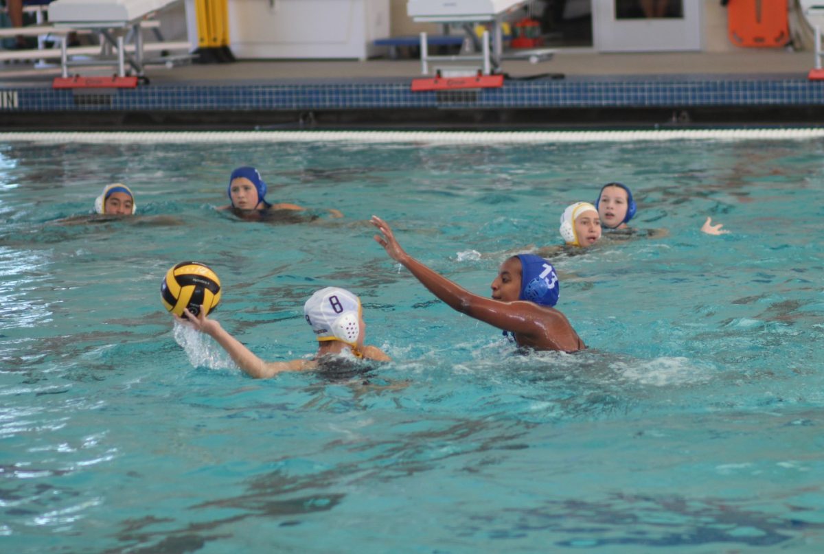 Senior Amara Raab defends a Trojan while facing off with Anderson during their district tournament on Sept. 27. 
