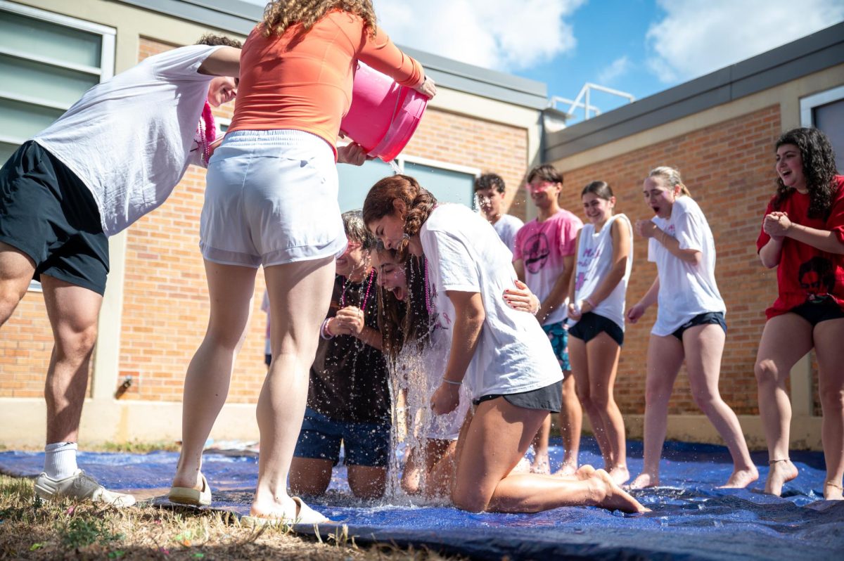 On Oct. 17, 2025, PALs junior Fernando Kramer, senior Sara Hamlet, and senior Lexi Rosenblatt get dunked by a water bucket during Pink Week.