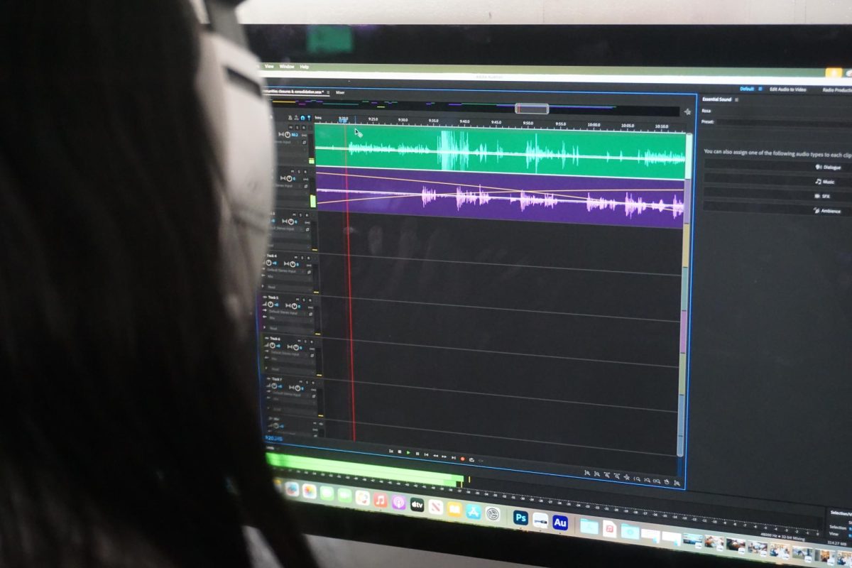A Digital Design and Media Production student edits a podcast in Adobe Audition.