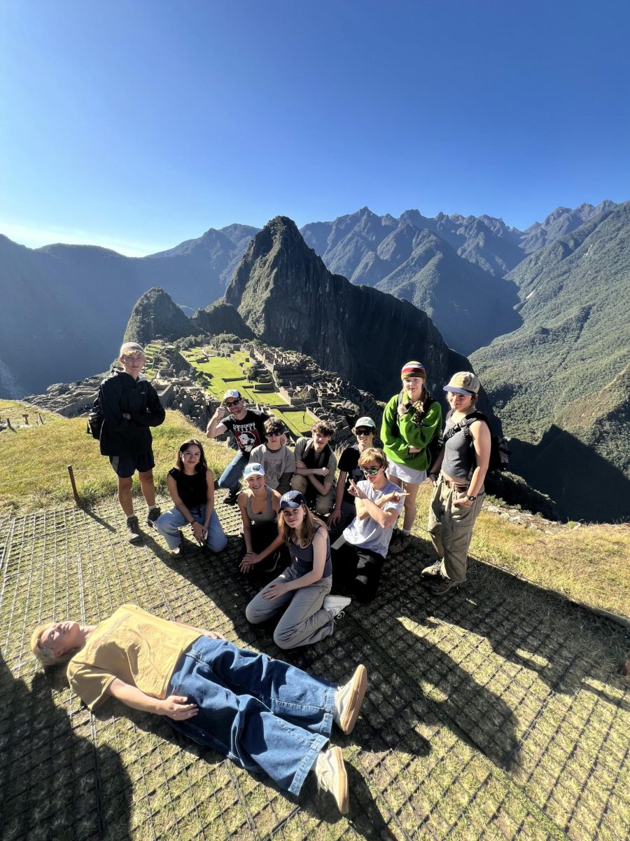 History teacher Greg Anderson stands with students before the ruins of Machu Pichu during EF trip to Peru in July 2024. Photo courtesy of Anderson. 